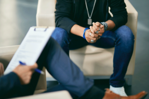 Legs of a person discussing the steps of recovery with their therapist