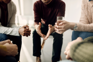 Hands of people at a mental health support group in Boise, ID