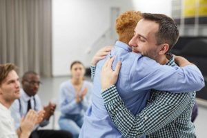 two people hug possibly after taking The first step to recovery