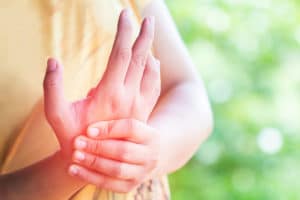 one hand rubbing another possibly after experiencing Numbness after smoking crystal meth