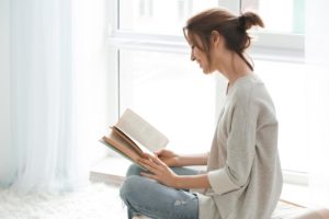 a person reads a book about Overcoming codependency