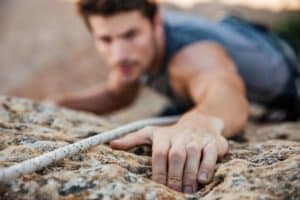 a person with an Adrenaline addiction rock climbs