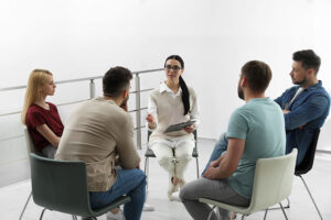 People sitting in a circle at a painkiller addiction treatment program