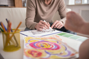 Hands of a person experiencing art therapy benefits