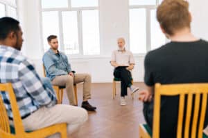 People in group therapy session talking about the early signs of a dual diagnosis